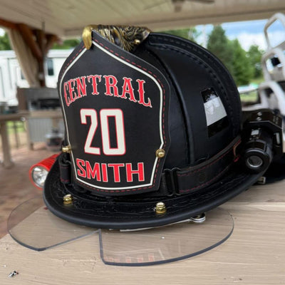 Fire helmet with 'Central Smith' and number '20' on a wooden surface