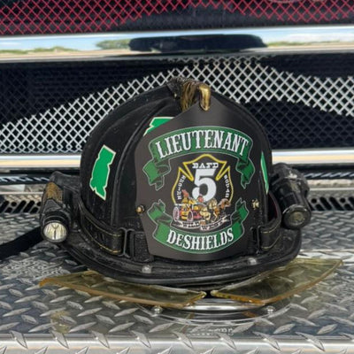 Firefighter helmet with 'Lieutenant' and 'DFAF 5' insignia on a vehicle grill.