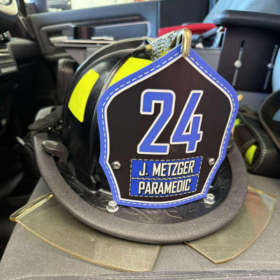 Paramedic helmet with number 24 and name 'J. Metzger' on a car seat.