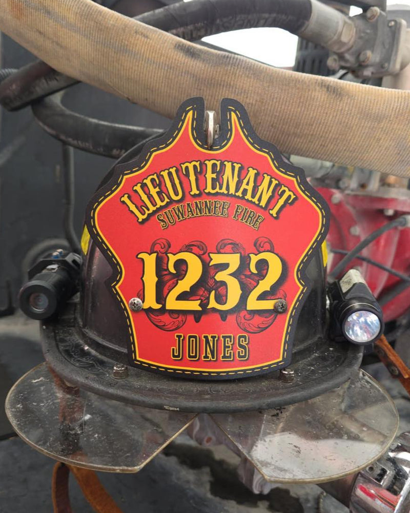 Firefighter helmet with 'Lieutenant 1232 Jones' on a fire truck background