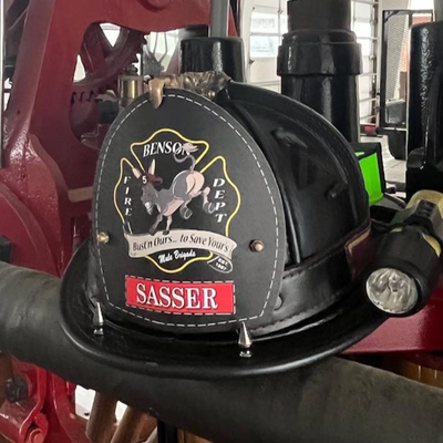 Red fire engine with a Sasser pump in a garage setting