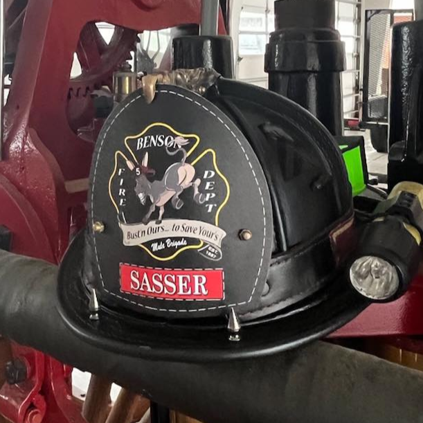 Red fire engine with a Sasser pump in a garage setting